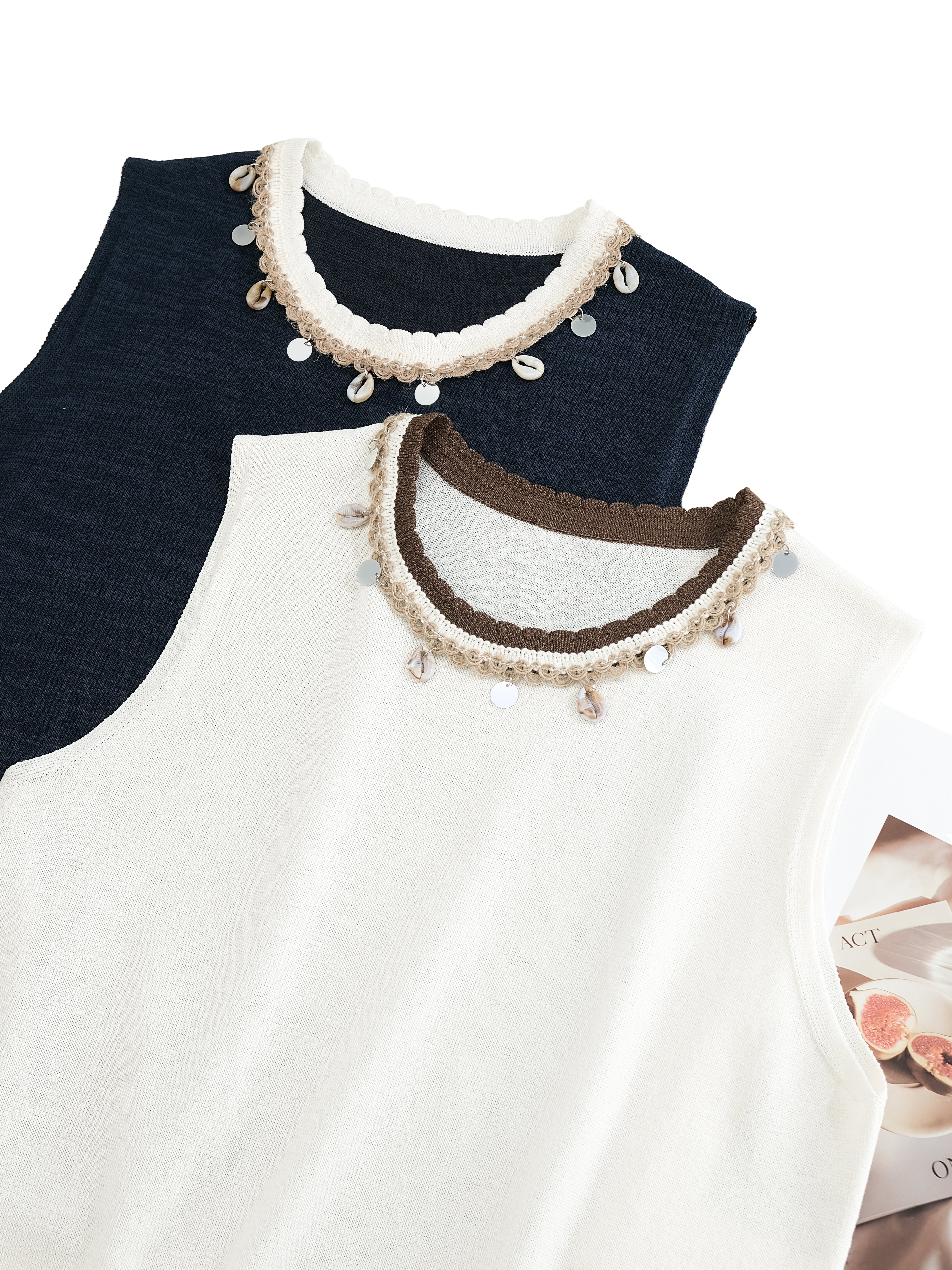 Two tops with decorative collars in navy and white on a white background